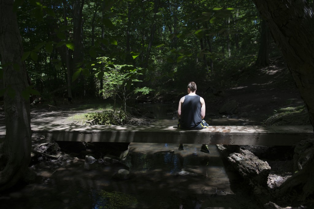 Summary: Newlyweds, Tyler and Jessica Rinallo, experience many of the same challenges other couples face as they adjust to married life together. In addition to the simple changes, their lives are transforming in more complex ways as Tyler transitions from being a female to a male. Tyler Rinallo rests on a bridge at his favorite hiking spot on June 22, 2015 in West Irondequoit, N.Y. Tyler described this location as his peaceful place where he can just be himself.